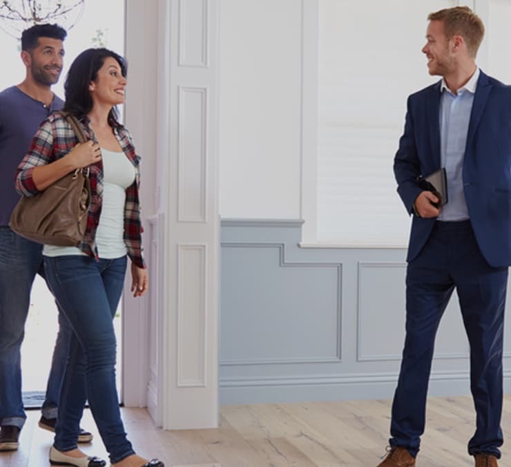A BlueKey Living agent welcoming a couple to a viewing