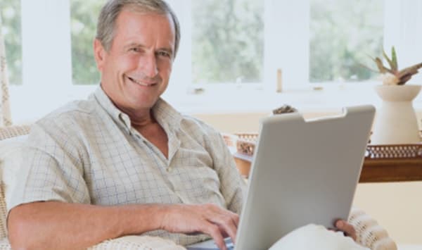 A retired landlord relaxing at home with a laptop